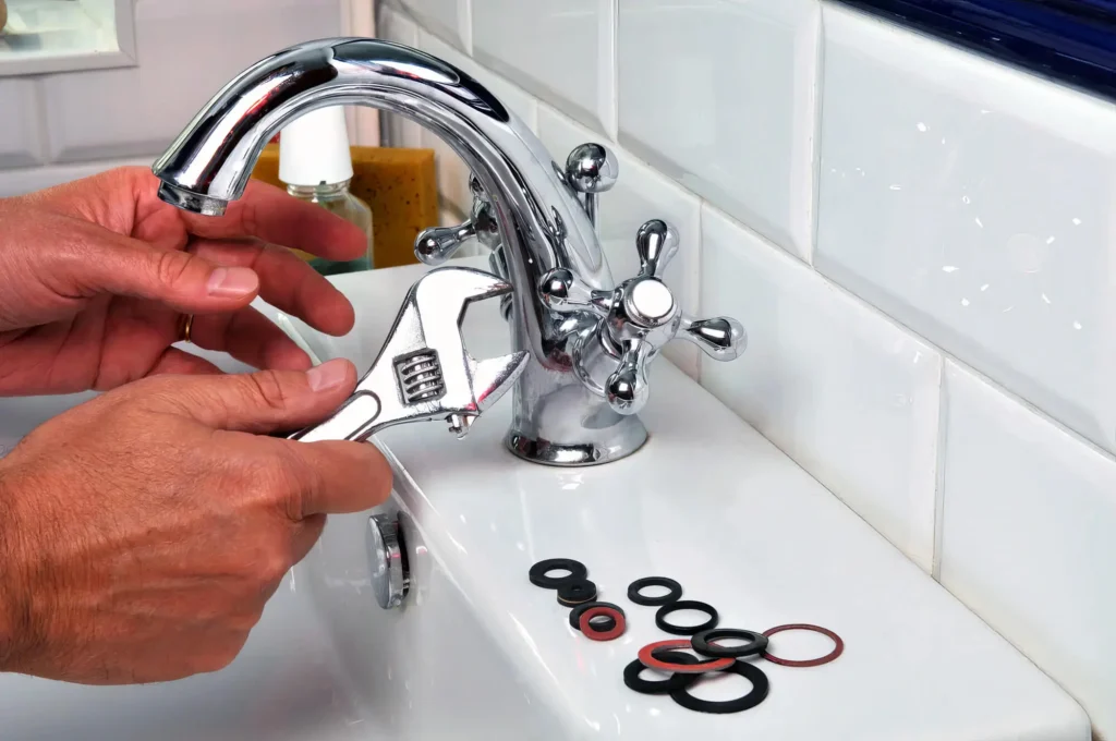 Plumber performing maintenance on a bathroom faucet in Boca Raton