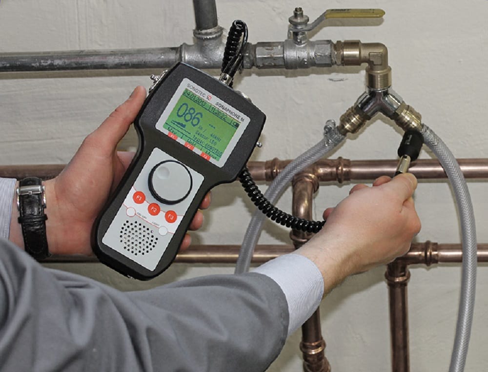Plumber testing pipes with electronic leak detection equipment in Boca Raton