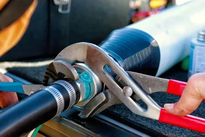 Technician tightening an industrial pipe connection in Boca Raton