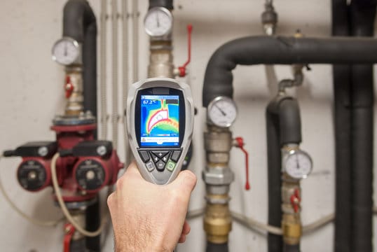 Plumber using a thermal imaging camera to inspect pipes in Boca Raton