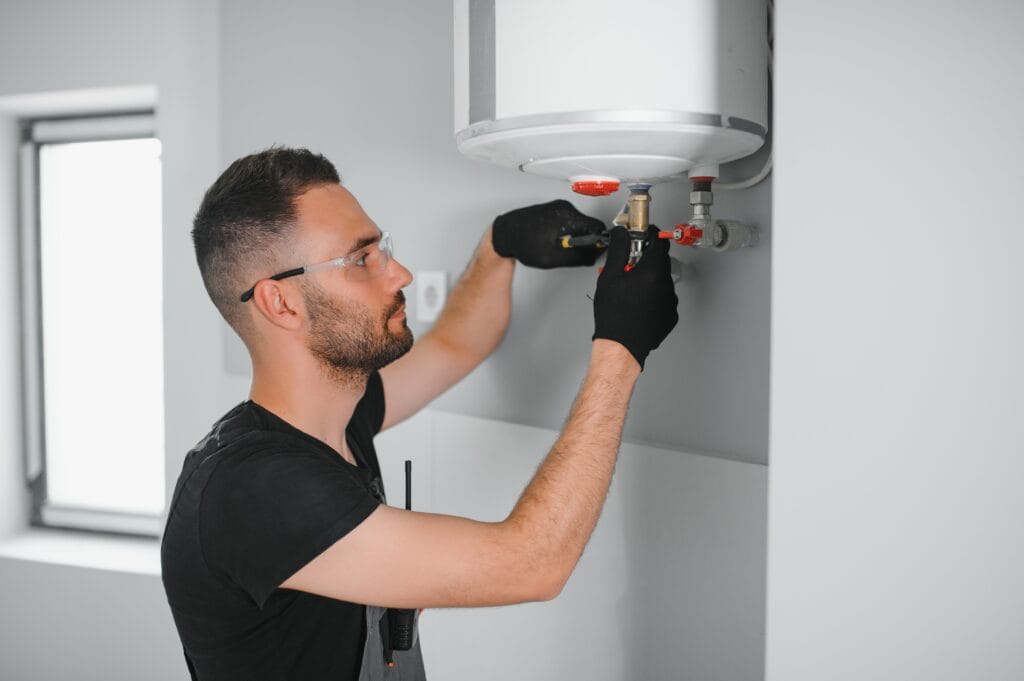 Technician performing water heater maintenance in Boca Raton