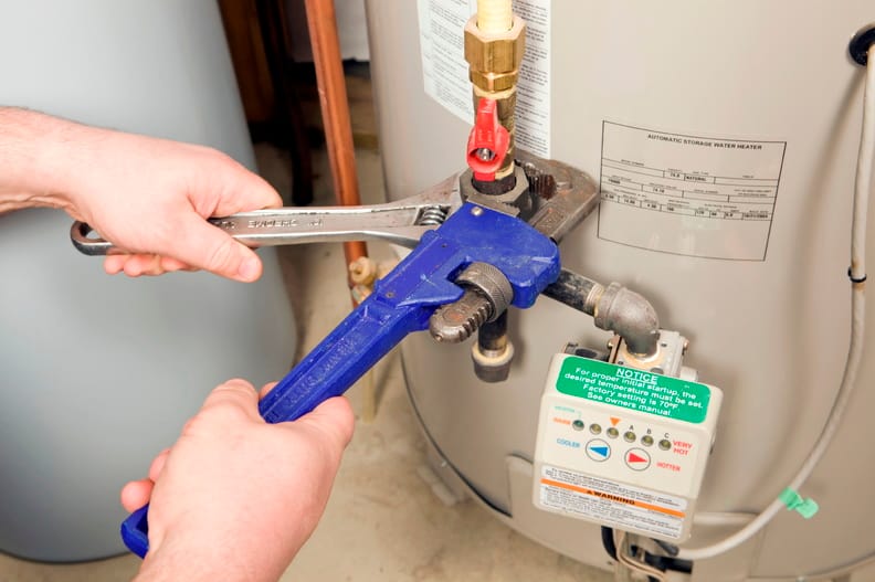 Plumber repairing a water heater valve in Boca Raton